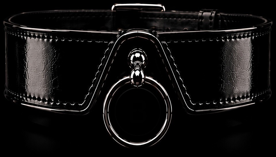 Backstreet Divine — a wide glossy black patent leather collar with polished chrome hardware and a central chrome O-ring bearing a BD monogram.